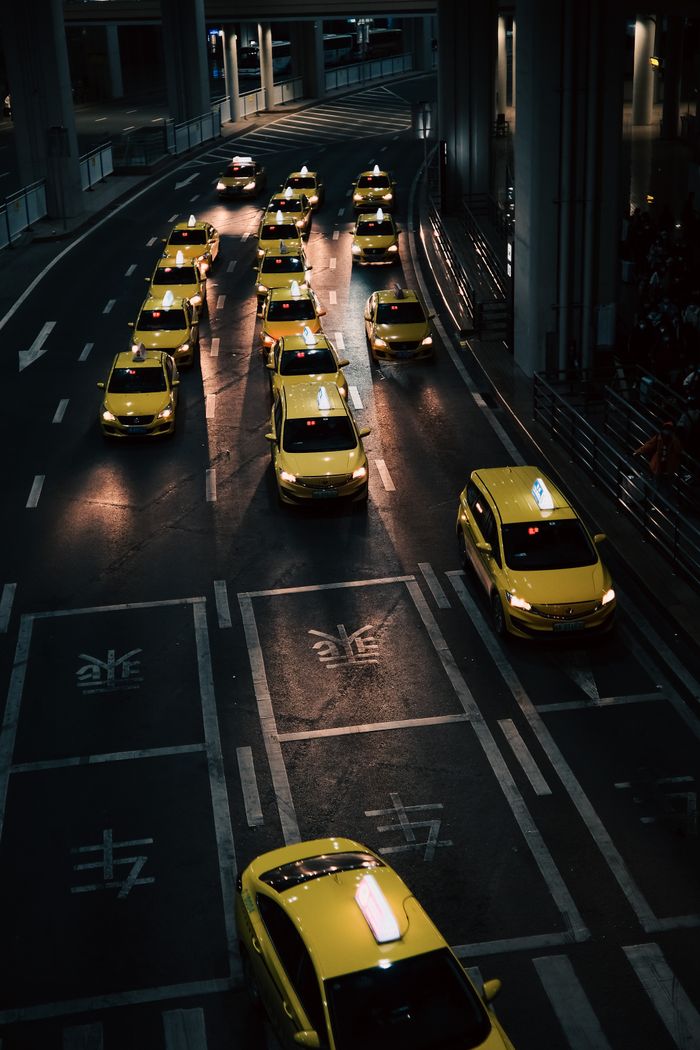 The Art of Drawing Readers In: Your attractive post title goes here High angle view of lined yellow taxis on urban street during nighttime.